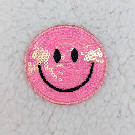 PINK Sequin Happy Face HAT/POCKET Patch, round pink sequin patch with a smiling face design featuring black eyes and a curved black mouth.