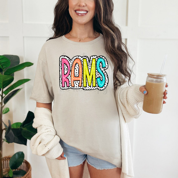 Rams Dalmatian Dots DTF Heat Transfer, colorful and playful foam-dotted design on a beige t-shirt worn by a smiling woman.