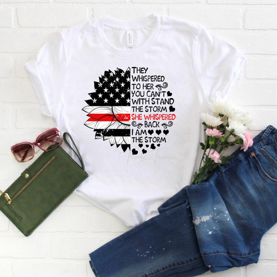 Product I am the storm Red Line sunflower flag Sublimation Transfer, white T-shirt with patriotic sunflower design featuring American flag elements and inspirational quote.