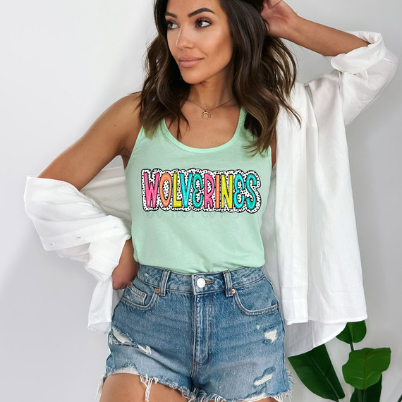 Wolverines Dalmatian Dots DTF Heat Transfer, colorful patterned text on a mint green tank top worn by a woman.