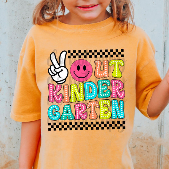 Peace Out Kindergarten DTF Heat Transfer, colorful and playful design on a child's orange T-shirt with a peace sign, smiley face, and vibrant lettering.