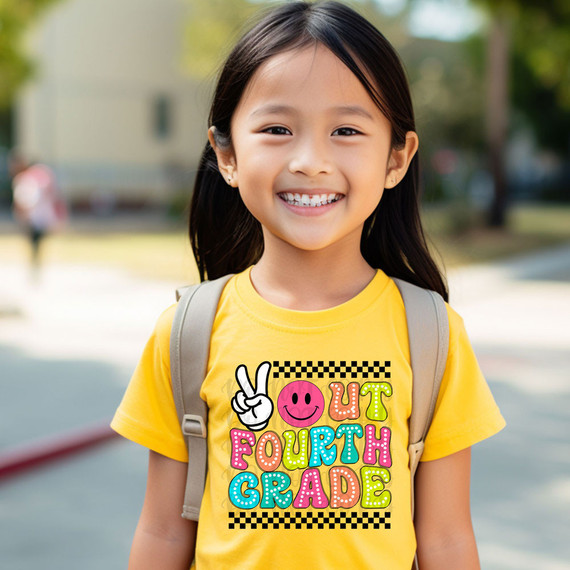 Peace Out Fourth Grade DTF Heat Transfer, a colorful and fun design featuring a peace sign hand, smiley face, and vibrant text on a yellow T-shirt worn by a smiling young girl.