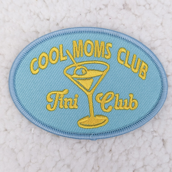 Cool Moms Club Embroidered HAT/POCKET Patch, light blue oval patch with yellow embroidery featuring a martini glass and the text 'Cool Moms Club' and 'Tini Club'.