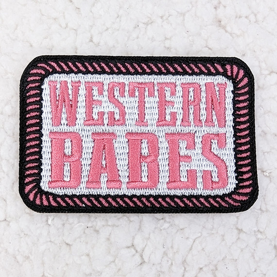 Western Babes Embroidered HAT/POCKET Patch, pink and white embroidered patch with black border featuring the text 'Western Babes'.