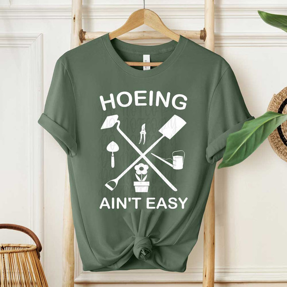 Hoeing Ain't Easy Gardening WHITE DTF Heat Transfer, green t-shirt with gardening tools and flower design.