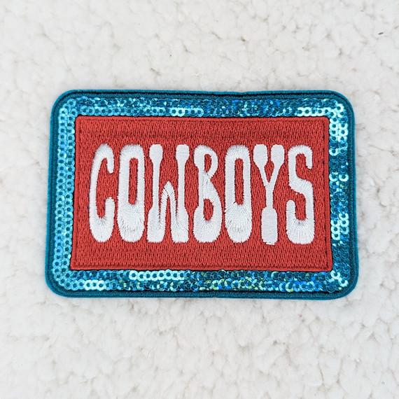 Cowboys Embroidered Sequin HAT/POCKET Patch, vibrant rectangular patch with red background, white embroidered 'COWBOYS' text, and blue sequin border.