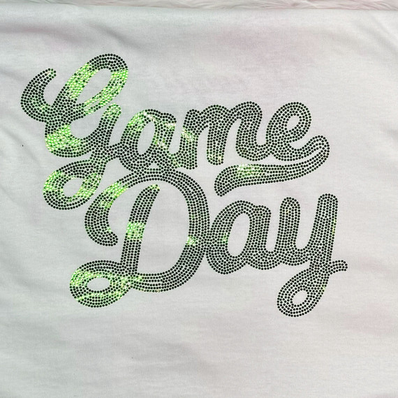 GREEN Game Day Spangled Transfer, a decorative design featuring green and black rhinestones spelling 'Game Day' on a white fabric background.