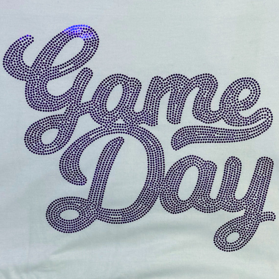 ROYAL Game Day Spangled Transfer, close-up of a decorative transfer with the phrase 'Game Day' written in stylish cursive using purple rhinestones or dots on a light fabric background.