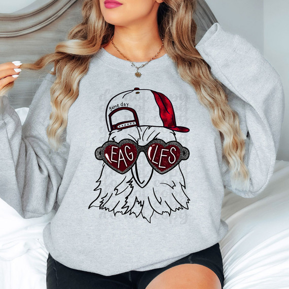 Eagles Mascot RED DTF Heat Transfer, a graphic of a bald eagle wearing sunglasses and a red cap, with the word 'EAGLES' on the lenses.