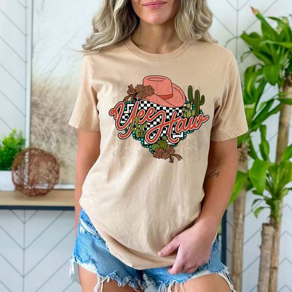 Yee Haw Checkered Western DTF Heat Transfer, woman wearing beige t-shirt with cowboy hat, cactus, and desert design