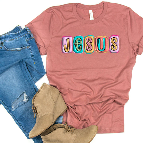 Jesus Faux Bubble Letters DTF Heat Transfer, colorful balloon-style bubble letters spelling 'Jesus' on a pink t-shirt.