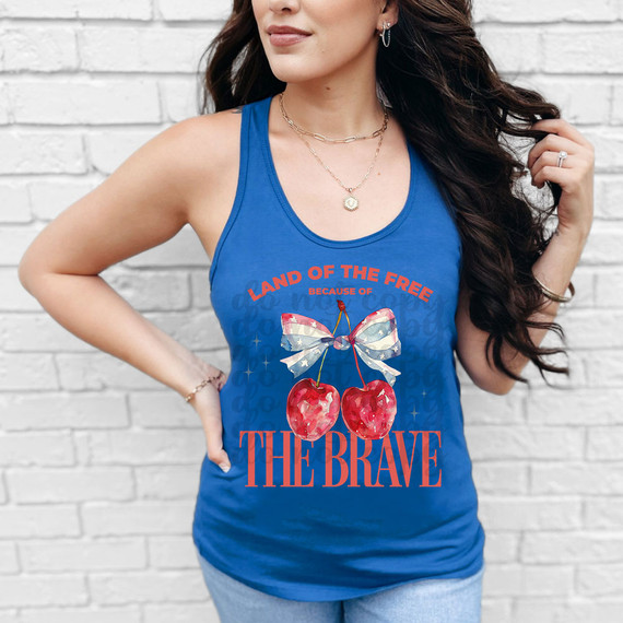 Land Of The Free Because Of The Brave Coquette DTF Heat Transfer, graphic tank top featuring cherries with a patriotic bow on a blue background.