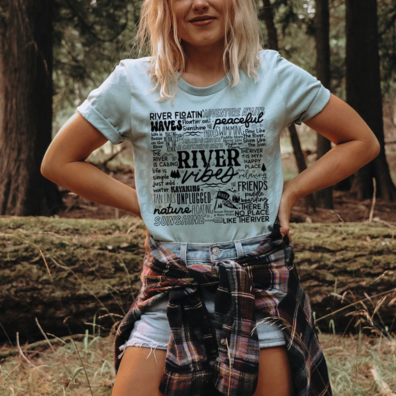 River Vibes DTF Heat Transfer, product featuring a scenic river and nature-themed design on a T-shirt worn by a woman outdoors.
