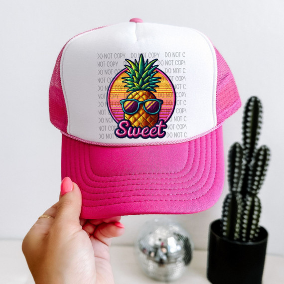Sweet Pineapple Faux Patch Sublimation Transfer, colorful pineapple wearing sunglasses with the word 'Sweet' below on a pink and white trucker cap.