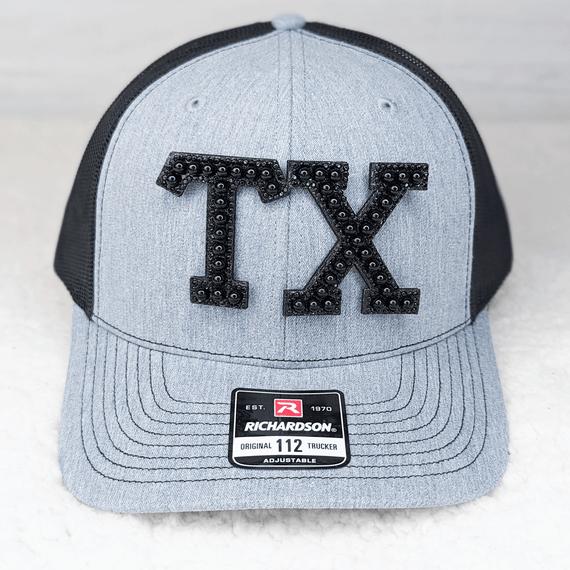 GLUE ON TX Black Pearl HAT/POCKET Patch, a gray and black trucker cap with a decorative black pearl patch featuring the letters 'TX' on the front.