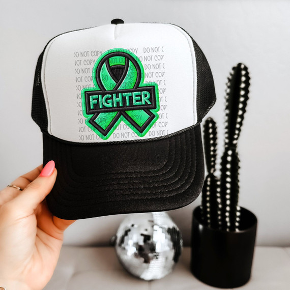 Green Ribbon Faux Patch Sublimation Transfer, embroidered patch with a green ribbon and the word 'FIGHTER' on a black and white baseball cap.