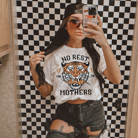 No Rest For The Mothers DTF Heat Transfer, woman taking a mirror selfie wearing a casual outfit with graphic t-shirt and distressed shorts.