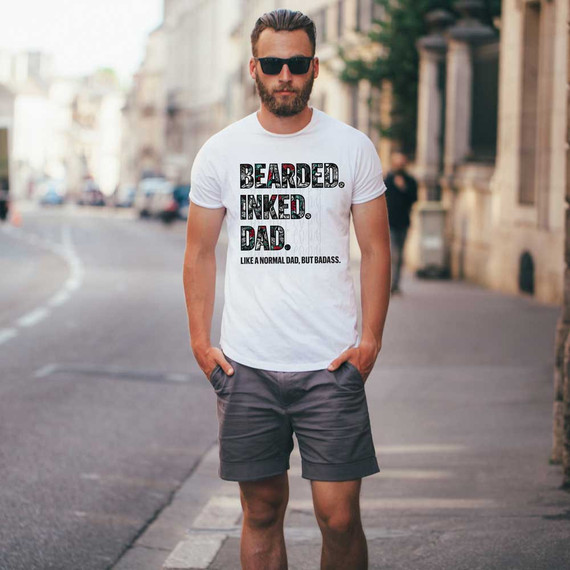 Bearded. Inked. Dad. DTF Heat Transfer, a man wearing a white t-shirt with bold text design in an urban street setting.