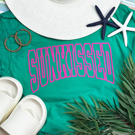 Sunkissed Pink PUFF Screen Print Heat Transfer, pink textured text on a teal t-shirt with summer accessories and greenery around.