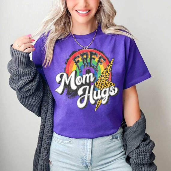 Free Mom Hugs Leopard Bolt DTF Heat Transfer, colorful graphic with rainbow, leopard print lightning bolt, and bold text on purple t-shirt.