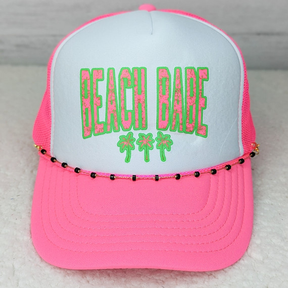 Black Beaded Hat Chain on a pink and white beach cap with colorful embroidered 'Beach Babe' text and palm trees design.