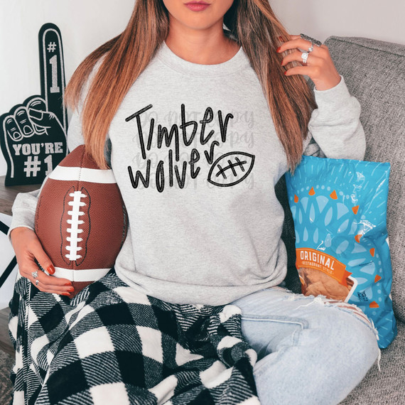 Timberwolves Football DTF Heat Transfer, woman wearing a sweatshirt with Timberwolves football logo design.