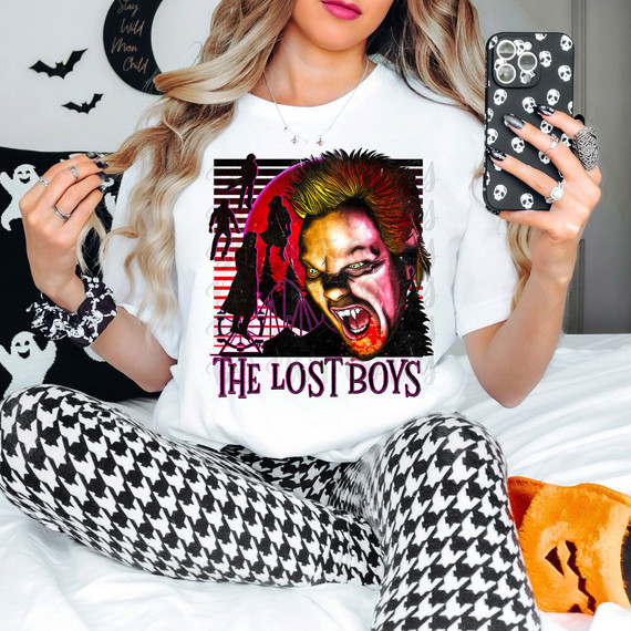 The Lost Boys DTF Heat Transfer, Halloween-themed graphic t-shirt featuring Pennywise the Clown from IT with children silhouettes and horror elements.