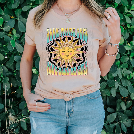 Seek What Sets Your Soul On Fire DTF Heat Transfer, colorful graphic design of the sun with face and floral crown on a woman's t-shirt.