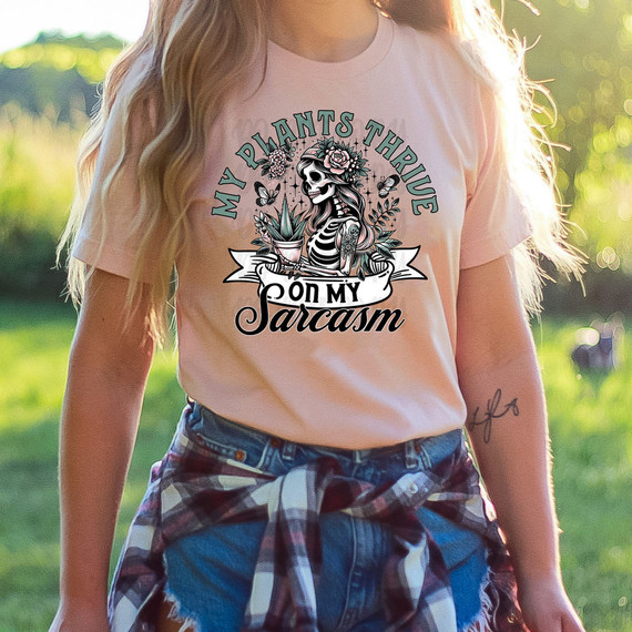 My Plants Thrive On My Sarcasm, DTF Heat Transfer - T-shirt design featuring a skeleton woman with plants, flowers, and butterflies, humorous and sarcastic graphic for plant lovers.