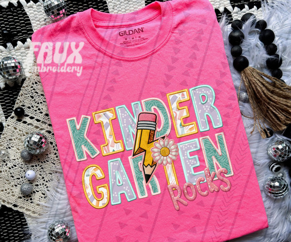 Kindergarten Rocks Pink DTF Heat Transfer, colorful and embroidered graphic design on pink t-shirt featuring a pencil, flower, and playful text.