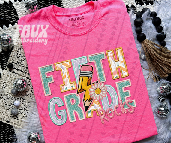 Fifth Grade Rocks Pink DTF Heat Transfer, colorful school-themed design with a pencil, lightning bolt, and daisy on a pink T-shirt.
