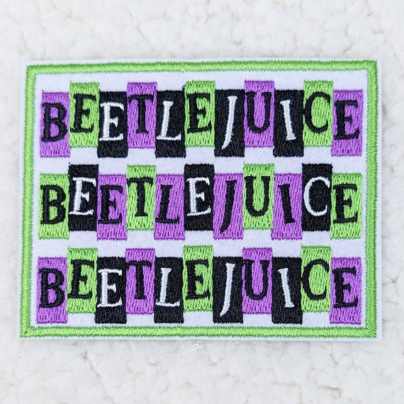 Beetlejuice Embroidered HAT/POCKET Patch, colorful embroidered patch featuring the name Beetlejuice in black, white, purple, and green threads on a white background.