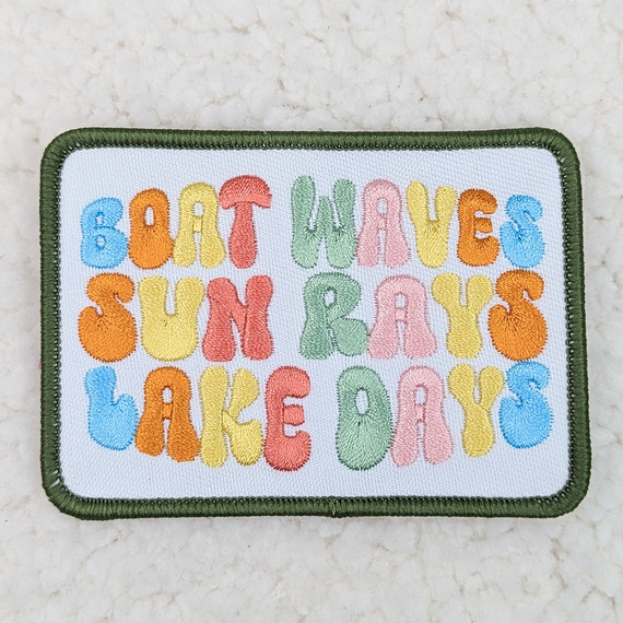 Boat Waves Sun Rays Embroidered HAT/POCKET Patch, colorful embroidered patch with the text 'Boat Waves Sun Rays' on a white background with a green border.