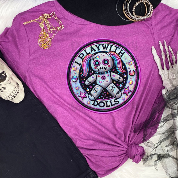 I Play With Dolls Faux Embroidery DTF Heat Transfer, colorful patch featuring a doll with rainbow hair and the phrase 'I Play With Dolls' on a pink T-shirt.