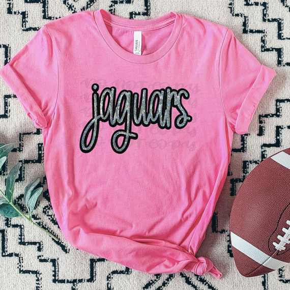 Jaguars Faux Sequin Patch DTF Heat Transfer, pink t-shirt with black and silver glitter Jaguars logo on front.