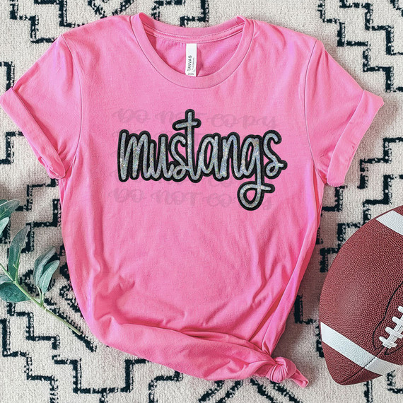 Mustangs Faux Sequin Patch DTF Heat Transfer, pink t-shirt with black and silver sequined Mustang logo and cross design on front.