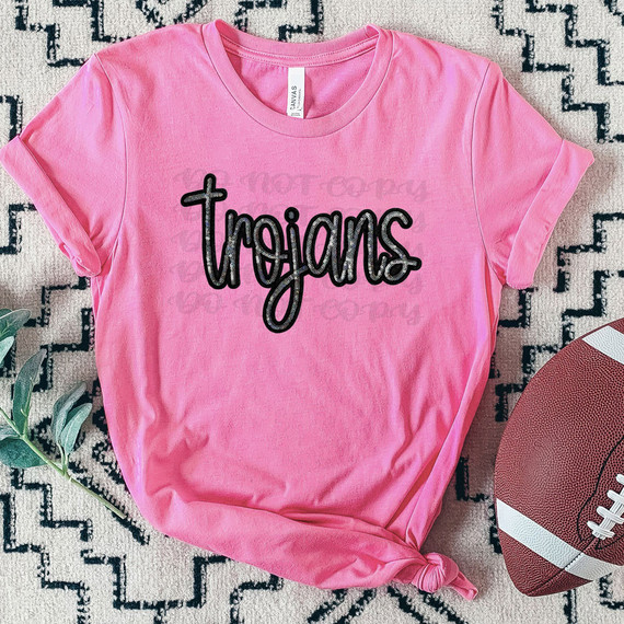 Trojans Faux Sequin Patch DTF Heat Transfer, decorative sequin patch on pink t-shirt with the word 'trojans' in black, for clothing embellishments.