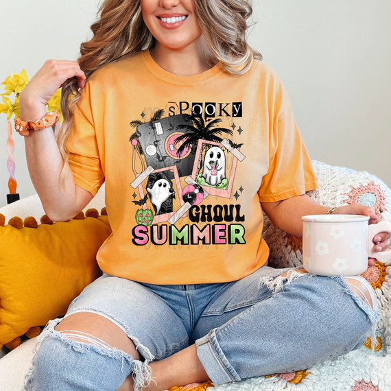 Spooky Ghoul Summer DTF Heat Transfer, Halloween-themed graphic design featuring ghouls, bats, pumpkins, and palm trees on a yellow T-shirt.