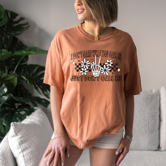 I Don't Care What You Call Me Just Don't Call Me DTF Heat Transfer, woman wearing orange T-shirt with graphic design and message