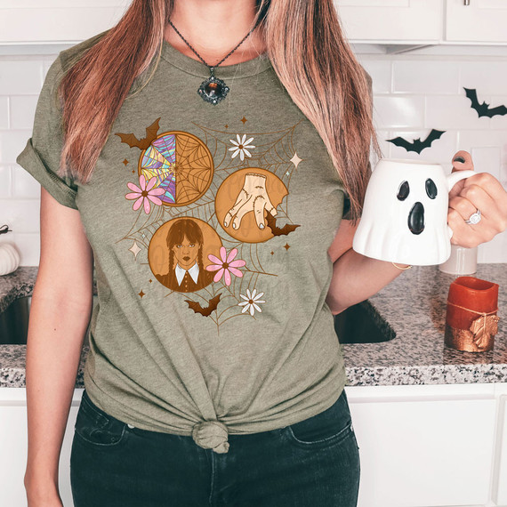 Wednesday Cookies DTF Heat Transfer, Halloween-themed design on a green T-shirt featuring a spider web, haunted moon, girl, bats, and flowers.