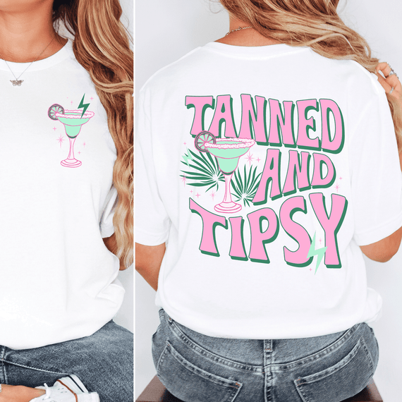 Tanned And Tipsy SET DTF Heat Transfer, colorful design featuring a cocktail glass with lime and lemon slices, palm leaves, and sparkles on a white T-shirt.