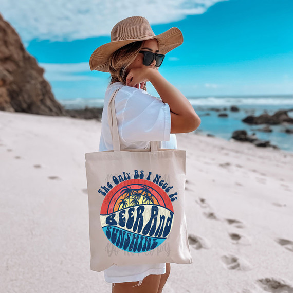 Beer And Sunshine DTF Heat Transfer, a colorful beach-themed design on a tote bag with palm trees, sunset, and waves, perfect for summer fashion.