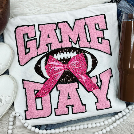 Pink Chenille Football Game Day with Sequin Bow Patch, close-up of decorative white T-shirt with pink and black embroidery of football and game day text.