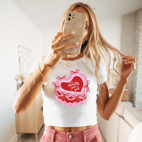 I'm Literally Just A Girl DTF Heat Transfer, a white t-shirt with a pink and red heart-shaped design and the text 'I'm literally just a girl' in the center.