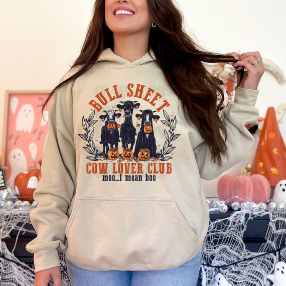 Bull Sheet Cow Lover Club DTF Heat Transfer, humorous Halloween-themed hoodie featuring three cows with pumpkin buckets and spooky decorations.