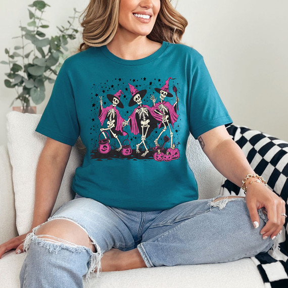 Skeleton Witches DTF Heat Transfer, colorful halloween-themed skeleton witches on a blue t-shirt.