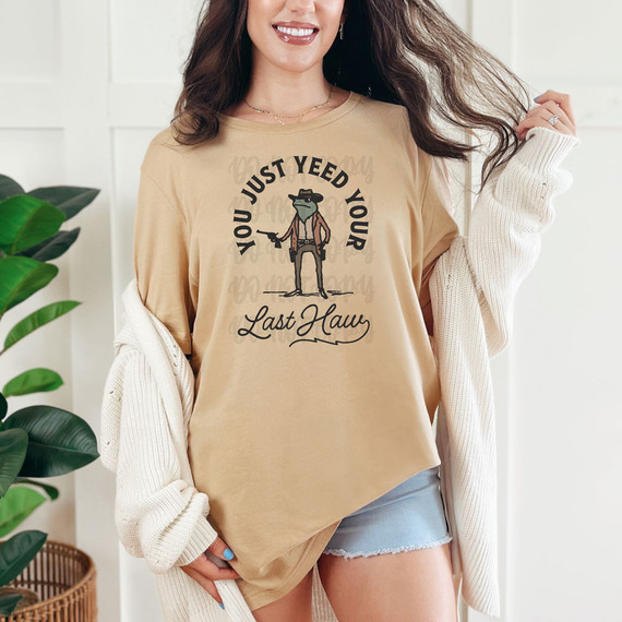 You Just Yeed Your Last Haw DTF Heat Transfer T-shirt, featuring a graphic design of a cartoon character in western attire with text around it.