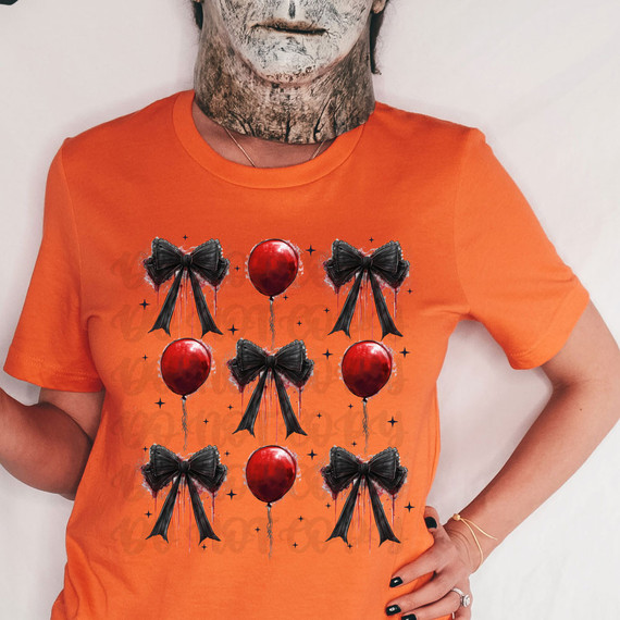 Red Balloon Coquette DTF Heat Transfer, decorative black bows and red balloons graphic on orange T-shirt.