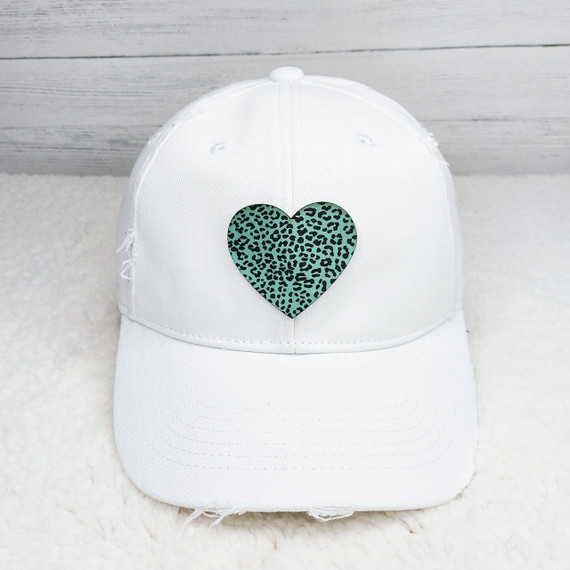 Leopard Heart FAUX Leather Patch, white baseball cap with a green heart featuring black leopard spots on the front.