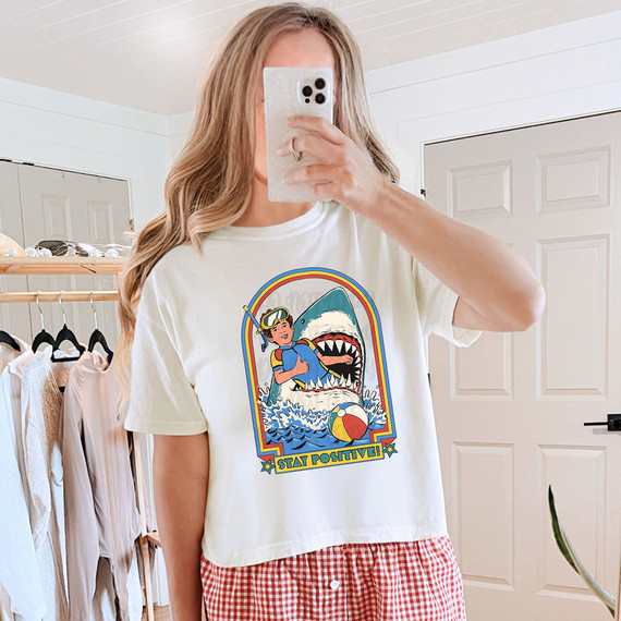 Stay Positive Shark DTF Heat Transfer, graphic design of a girl snorkeling with a shark and the text 'Stay Positive' on a white t-shirt.